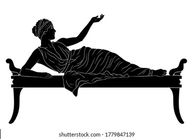 A Young Ancient Greek Woman Lies On The Bed And Gestures Isolated On White Background.