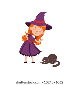 Young angry red-haired girl witch wearing purple dress and hat. Smiling kid character in costume scolds a cat. Trick or Treat Halloween concept. Vector flat cartoon illustration isolated on white.