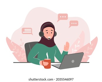 A Young Arab Girl Is Sitting At A Table At A Laptop With Headphones. Muslim Business Female, A Student In A Hijab, Working At Home Or In The Office. The Concept Of Equal Rights Of Women, Tolerance.