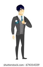 Young asian bridegroom in a wedding suit giving thumb up. Full length of bridegroom with thumb up. Cheerful bridegroom showing thumb up. Vector flat design illustration isolated on white background.