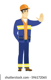 Young asian builder showing stop hand gesture. Full length of builder doing stop gesture. Serious builder with a stop gesture. Vector flat design illustration isolated on white background.