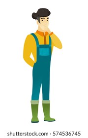 Young asian farmer in coveralls thinking. Full length of thinking farmer with hand on his chin. Farmer thinking and looking to the side. Vector flat design illustration isolated on white background.