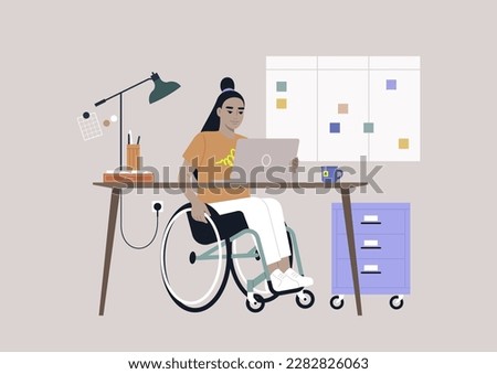 A young Asian person using a wheelchair works at a desk in the office