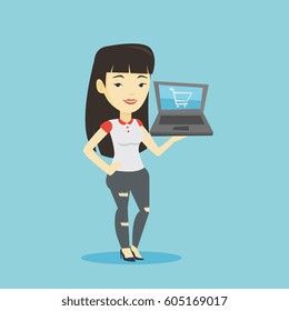 Young asian woman using laptop for online shopping. Female customer holding laptop with shopping trolley on a screen. Woman doing online shopping. Vector flat design illustration. Square layout.
