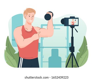 Young athletic man lifting dumbbell while recording video using camera for his online video channel. Online personal gym trainer