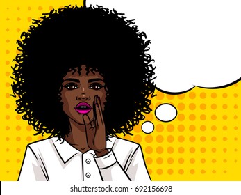 Young attractive Afro american girl wants to tell a secret. Portrait of a woman with dark skin and curly hair. Girl holding a hand near mouth.