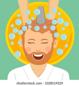 Young bearded man in barbers getting washed his hair with shampoo