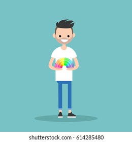 Young bearded man playing with a plastic rainbow spring toy / flat editable vector illustration, clip art