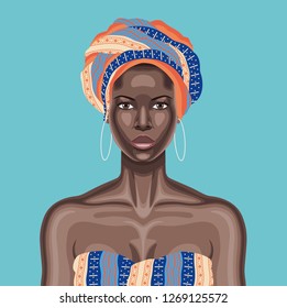 Young beautiful black woman with multicolor head wrap and white hoop earrings