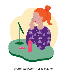 Young beautiful ginger woman applying contact lens sitting at the table near the mirror. Smiling girl wearing contact lenses. Female cartoon flat character on white. Vector illustration.