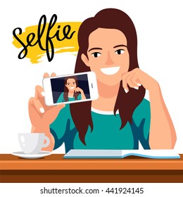 Young beautiful girl doing selfie at the table. Student in a cafe with a cup of coffee and a book. The trend calligraphy. The word "Selfie" on a smear of the yellow ink.