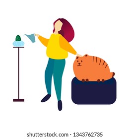 Young beautiful girl in a yellow sweater waters a cactus from a watering can and strokes a huge red tabby cat. Stay at home concept