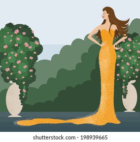 The young beautiful woman in a long shiny yellow dress smiling and posing in front of garden with vases with floral trees.  