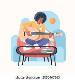 A young black afro musician playing his guitar and singing, sitting on the couch and desk with coffee in front of him vector illustration. used for poster, music album cover and other