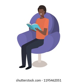 young black man reading book in the sofa