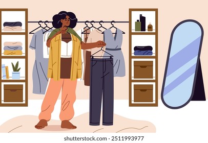 Young black woman chooses stylish outfit. African American holds hangers with clothes in front of mirror. Person makes choice of look on wardrobe rack, rail in dressing room. Flat vector illustration