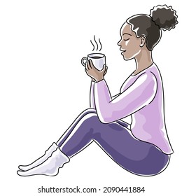 Young black woman sitting with a cup of coffee, side view
