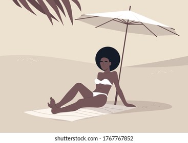 Young black woman sitting on the beach under umbrella, summertime vacation, hot tropical climate