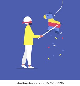 Young blindfolded indian male character hitting a colourful pinata with a stick, celebration party