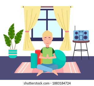 Young blond guy meditating on pink square rug in living room. Sports mats, large fitness ball. Stereo system on round table, potted plant. Cozy living room interior. Do yoga, relax. Stay home