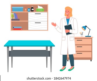 Young Blond Woman Doctor Or Veterinarian In A Hospital Coat In Medical Office With A Clipboard. Table For Examination Of Patients Or Pets. The Interior Of Doctor's Office. Reception At The Vet