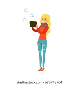 Young blonde smiling woman with a tablet standing and communicating in social networks colorful character vector Illustration