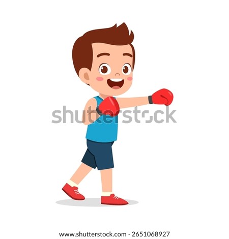 Young Boy in Boxing Stance with Red Gloves, Wearing Blue Shirt and Smiling Confidently