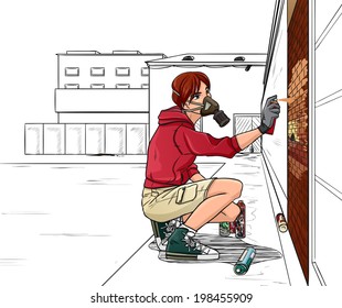 Young boy draws graffiti on the wall. Urban background.