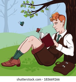 Young boy reading a book under a tree