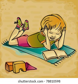 young boy reading on a carpet