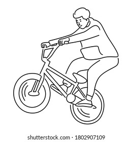 Young boy showing off freestyle trick with bicycle