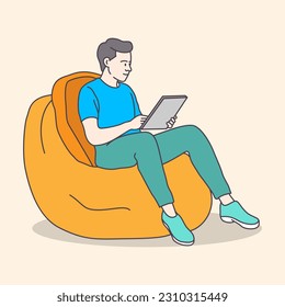 Young boy working on a bean bag chair with a laptop using from home, flat coloring line art minimal illustration 