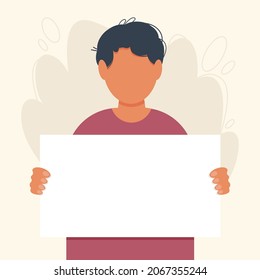 Young brunette man holding in hands a blank sign or poster. Boy calls to action. Expressing a point of view concept. Political, social or personal position on a peace protest, demonstration.