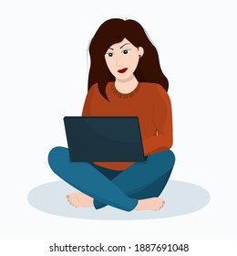 young brunette woman sitting on the floor and working on a laptop on a white background. the concept of working and learning from home and freelancing
