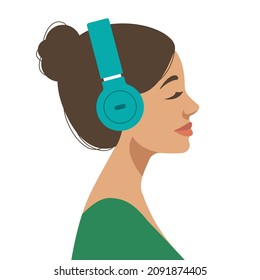 young brunette woman wearing headphones and listening to music or podcast
