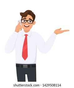 Young business man in formal speaking or talking on the mobile, cell or smart phone. Male person showing, presenting or pointing hand palm to copy space. Modern lifestyle, digital technology device.