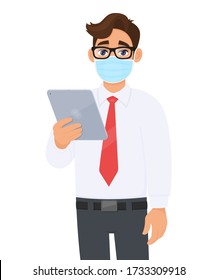 Young business man in safety medical mask, holding tablet computer device. Person using digital touch pad. Modern technology lifestyle. Corona virus epidemic outbreak. Cartoon illustration in vector.