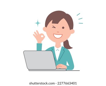 A young business woman giving an OK sign in front of a computer