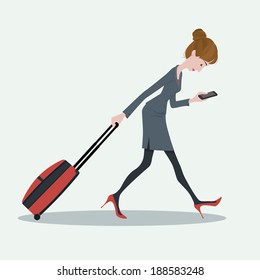 Young business woman pulling the luggage busy with mobile phone