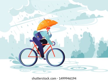 Young businessman going to work under the autumn rain. Businessman with umbrella on bicycle. Responsible worker.    Сoncept of commitment. Eco transport. Autumn time. Windy rainy day with gray clouds.