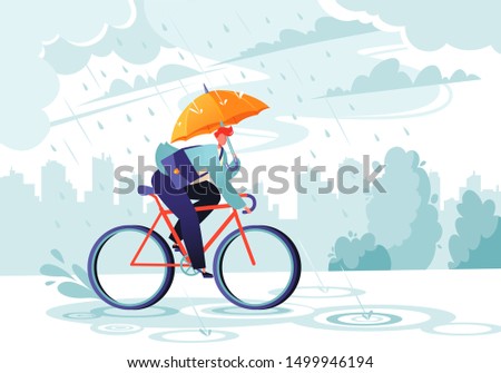 Young businessman going to work under the autumn rain. Businessman with umbrella on bicycle. Responsible worker.    Сoncept of commitment. Eco transport. Autumn time. Windy rainy day with gray clouds.