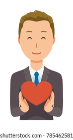 A young businessman is holding a heart