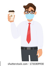 Young businessman in safety medical mask showing coffee cup. Person holding paper mug. Male character in formal wear with eyeglasses. Corona virus epidemic outbreak. Cartoon illustration vector design