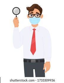 Young businessman in safety medical mask showing magnifying glass. Person holding magnifier lens. Male character in formal wear with eyeglasses. Corona virus epidemic outbreak. Cartoon illustration