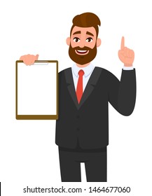 Young businessman showing blank clipboard and pointing finger up or one idea. Person holding notepad. Male character design illustration. Human expressions & gestures concept in vector cartoon style.