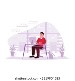 The young businessman was sitting in the office, working late into the night, accompanied by a cat against a tall building in the background. Trend Modern vector flat illustration.