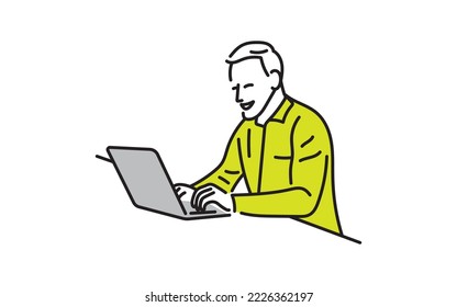 Young businessman sitting at table in the office using laptop computer.
