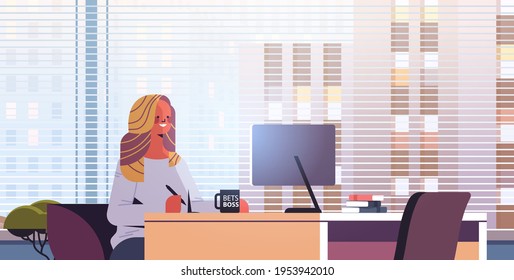 young businesswoman sitting at workplace and using computer businesswoman working in office