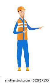 Young caucasian builder in hard hat pointing to the side. Builder pointing his fingers to the side. Builder pointing to the right side. Vector flat design illustration isolated on white background.