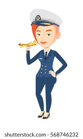 Young Caucasian Female Pilot Holding A Model Of Airplane In Hand. Female Airline Pilot In Uniform. Female Pilot With Model Of Airplane. Vector Flat Design Illustration Isolated On White Background.